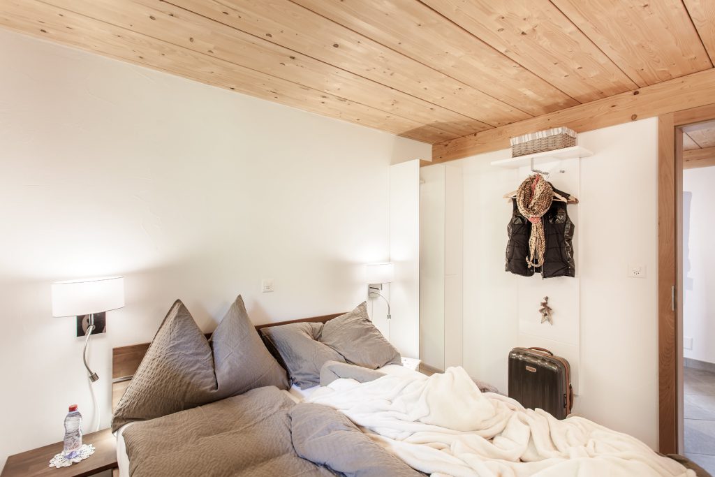 Bedroom with double bed and mountain view
